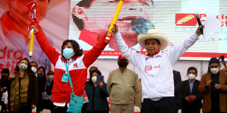 LIMA, PERU - MAY 18: Presidential candidate Pedro Castillo (R) and Vice Presidential candidate Dina Boluarte (L) greet supporters during a campaign event to present his working team ahead of the Presidential runoff at Estadio El Dorado on May 18, 2021 in Puente Piedra, Lima, Peru. (Photo by Raul Sifuentes/Getty Images)